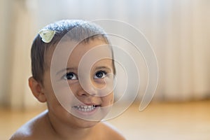 white butterfly on the head of a baby. Happy little boy with a butterfly on his head. copy space