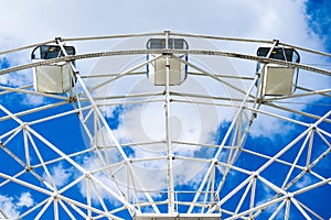 White cabins ferris wheel against the sky