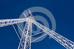 White cable car steel pylon against blue sky