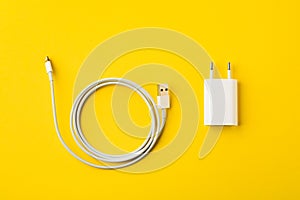 White cable for phone yellow background