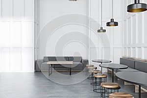 White cafe interior with gray sofas