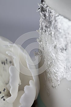 White Cake with Silver Leaf Decoration and Icing Sugar Flower