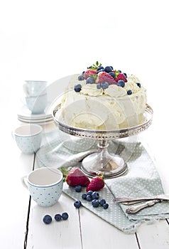 White cake with whipped cream and berries