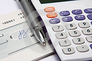 White calculator with a pen and a signature