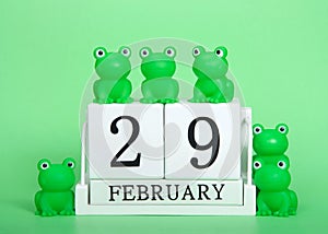 Wood blocks calendar February 29 with frogs, Leap Year, on green photo