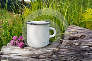 White campfire enamel mug mockup with red clover