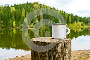 White campfire mug mockup with river bank view photo