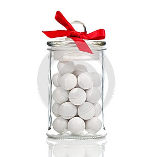 White candies, Gumballs in glass jar photo