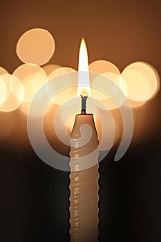 White candle on dark background