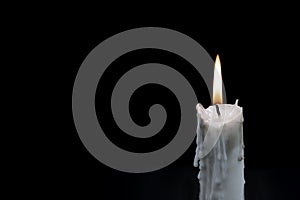 White candle on dark background. Memory photo. One candle with fire on black. In memoriam banner template photo