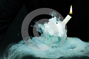 White candle in smoke