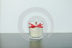 White candles with a red wick on a light background