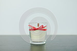 White candles with a red wick on a light background