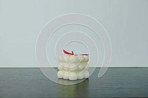 White candles with a red wick on a light background