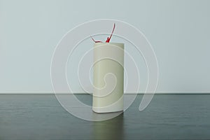 White candles with a red wick on a light background