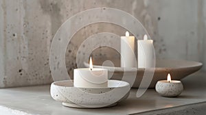 The white candles seem to amplify the raw and natural beauty of the concrete holders highlighting their unique photo