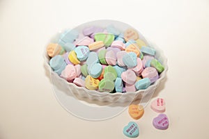 White candy dish full of candy hearts