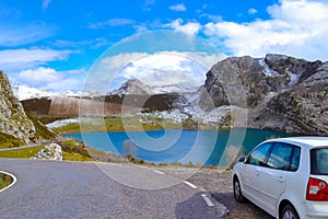 White car in Enol Lake in Picos de Europa, Asturias, Spain. Beau