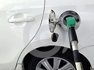 White car fuel filler at fuel station. Fuel dispenser at gas station.