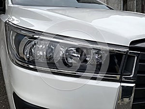White car with Headlights modern prestigious car close up