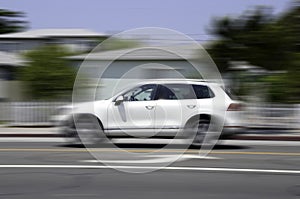 White car in motion on road