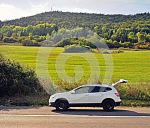 White car parked on the road