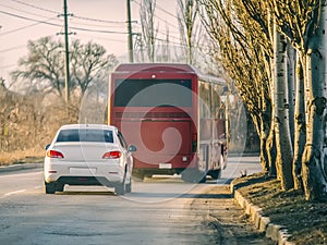 White car and red bus on the road