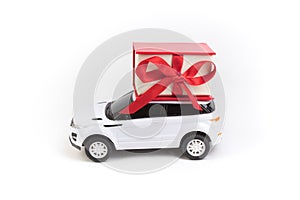 White car with red gift box, toy on isolated white background.