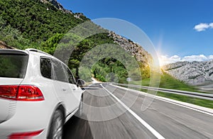 White car rushing along a high-speed highway.