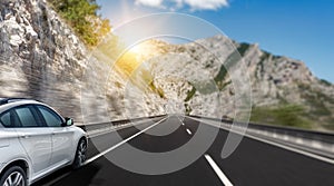 White car rushing along a high-speed highway.