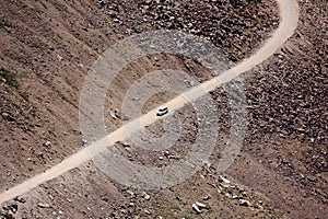 White Car on Secluded Road on Dry Mountain