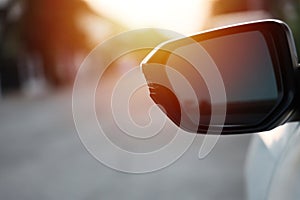 White car side mirror with evening sun