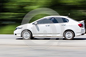 White car Speeding in road