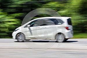 White car Speeding in road