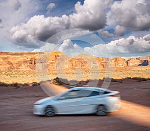 White car speeding up in Monument Valley National Park