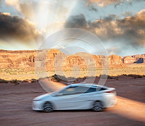 White car speeding up in Monument Valley National Park