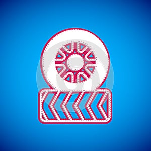 White Car tire wheel icon isolated on blue background. Vector