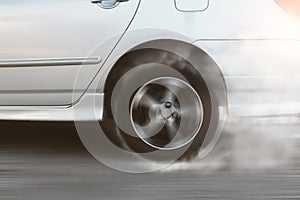 White car wheel drifting and smoking on track