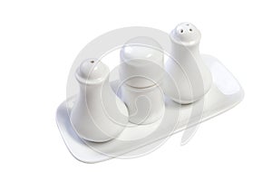 White caramic saltshaker and pepper container photo