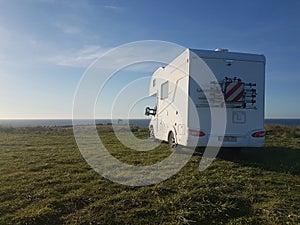 White caravan in front of the sea