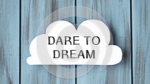 White card in cloud shape with text Dare to Dream on stylish