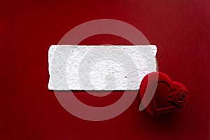 White card with congratulations and ring case on a red background. Valentine day card.