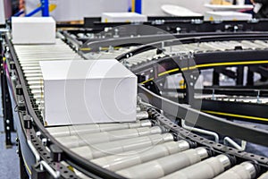 White cardboard boxes on conveyor belt industrial