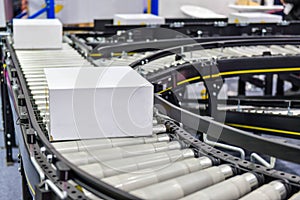 White cardboard boxes on conveyor belt industrial photo