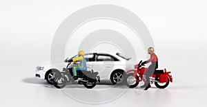 White cars and fallen motorcycle drivers. Concept about the dangers of speeding motorcycles.