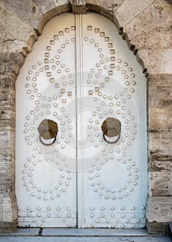 White casement doors to an old stone building. Facade building with doors