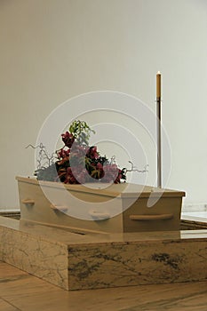 White casket with funeral flowers