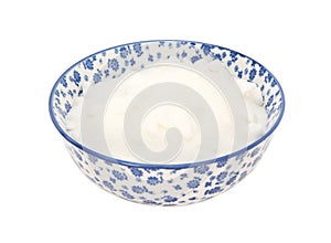 White caster sugar in a blue and white china bowl