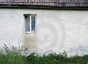 A cat resting at the window of a peasant house in Romania