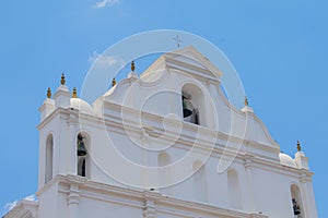 white catholic church facade with blue background